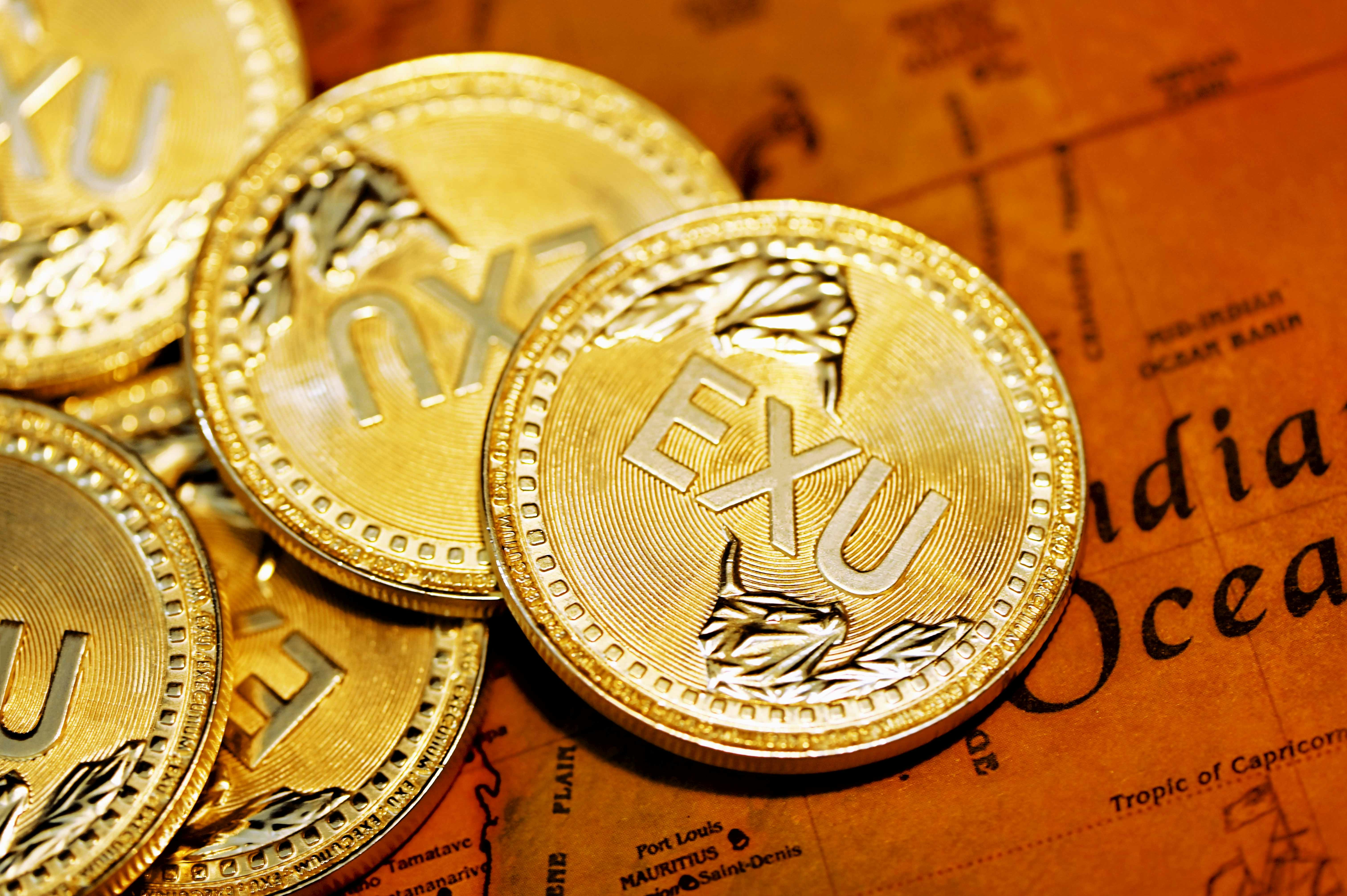 A variety of EXU coins on top of India Ocean map